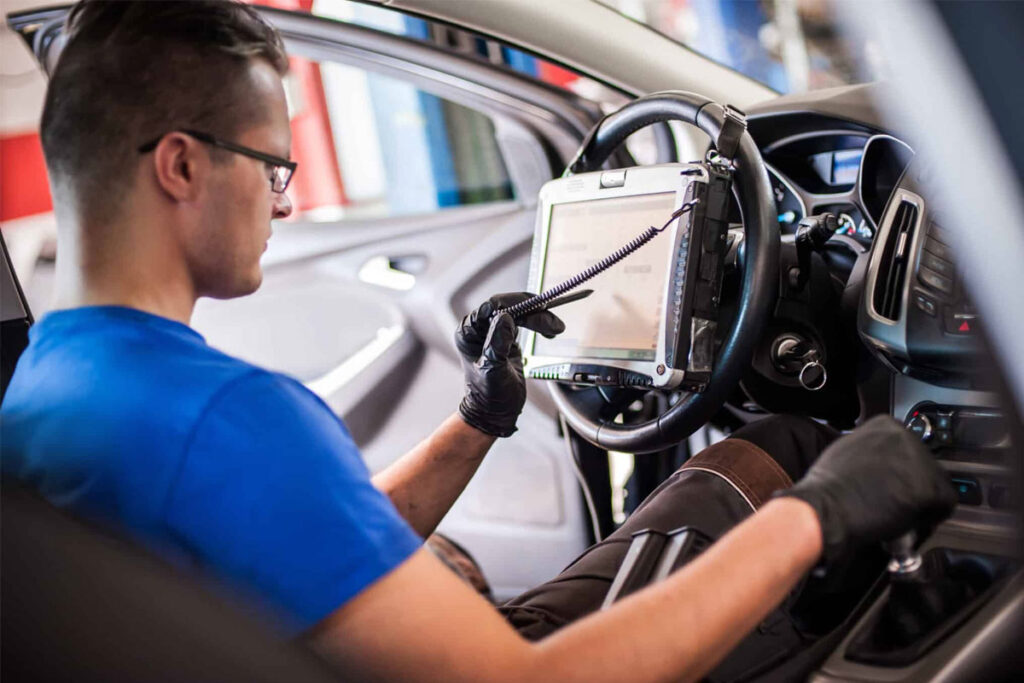 technician recalibrating sensors after windshield replacement