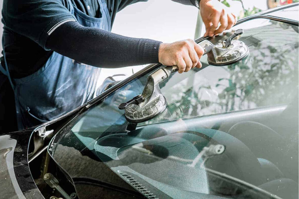Close-up of a windshield crack being repaired with resin injection