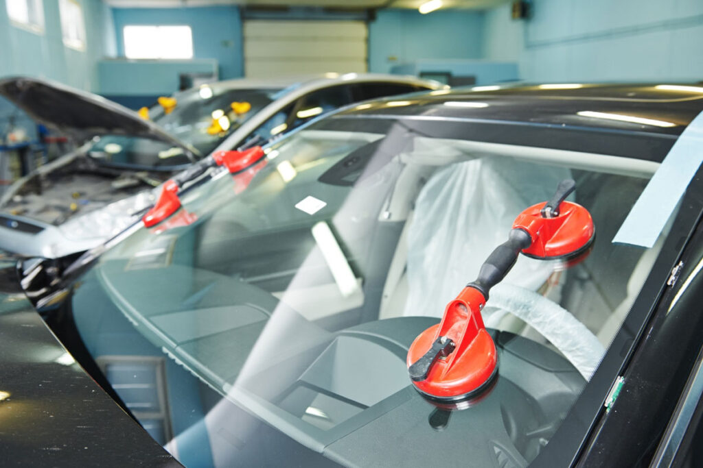 Cracked windshield in driver’s line of sight showing potential safety risk