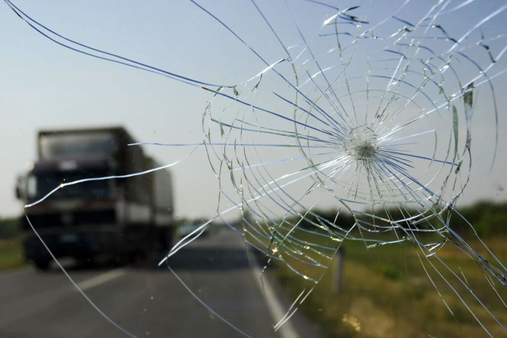 large crack and chip in a car windshield